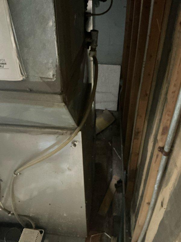 Conducted inspection of aging HVAC system in confined utility space, documenting deteriorated components including corroded piping and compromised electrical connections. Recommended complete system replacement due to extensive wear, limited accessibility for repairs, and potential safety concerns from accumulated dust and debris.