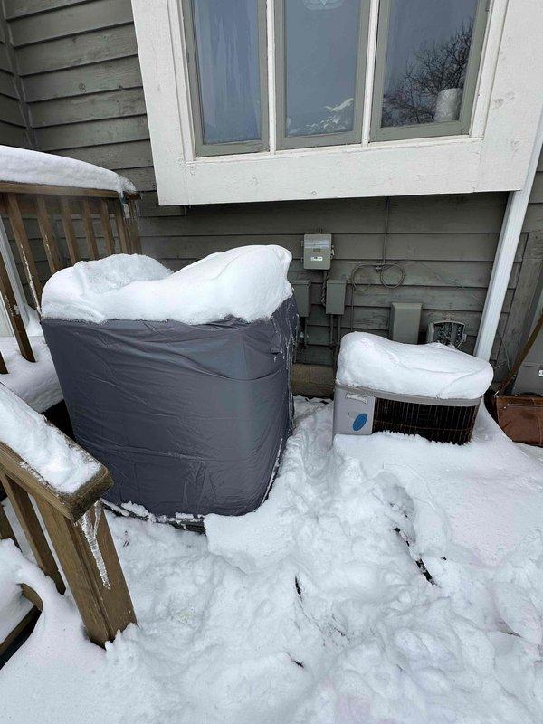 Conducted assessment of Bryant HVAC system for replacement. Exterior inspection revealed snow-covered condenser unit with protective cover installed. Interior inspection of basement mechanical room showed aging furnace with connected PVC ventilation pipes, visible ductwork, and associated components requiring upgrade.