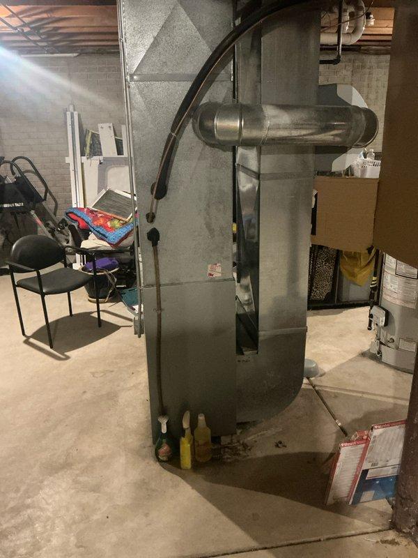 Conducted comprehensive evaluation of existing HVAC system in basement utility room. Documented condition of central furnace unit, associated ductwork, and exterior components including PVC venting configuration and utility connections. Prepared detailed replacement estimate for complete system upgrade.
