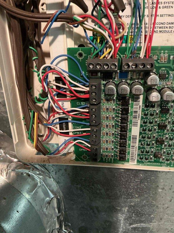 Responded to callback regarding control board issues. Performed diagnostic inspection of the main circuit board, examining all terminal connections and wiring harness integrity. Verified proper seating of all colored control wires (red, green, blue, yellow, white) at their respective terminal points on the PCB, ensuring secure connections at COM, GND and numbered terminals.