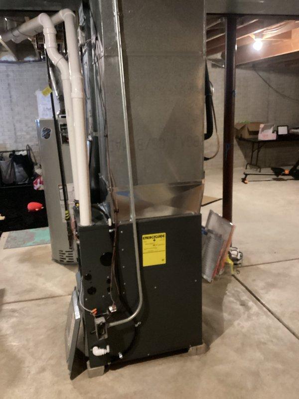 Successfully installed a new high-efficiency furnace in basement utility area, including proper connection to existing ductwork system and installation of PVC intake/exhaust venting. Unit was properly positioned on concrete floor with all electrical connections secured according to manufacturer specifications and verified for optimal operation.
