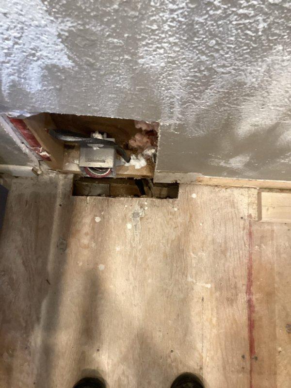 Completed installation of ventilation ductwork in ceiling space, requiring strategic access through ceiling drywall. Installed metal duct connection from main trunk line to exterior wall penetration, ensuring proper alignment and secure fastening to structural joists in the utility area.