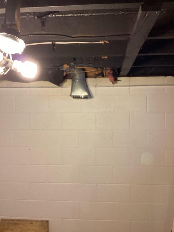Completed installation of ventilation ductwork in ceiling space, requiring strategic access through ceiling drywall. Installed metal duct connection from main trunk line to exterior wall penetration, ensuring proper alignment and secure fastening to structural joists in the utility area.