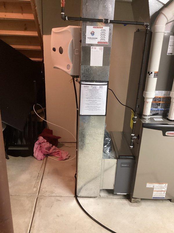 Successfully installed a complete HVAC system including indoor air handler/furnace unit in the basement utility area with proper ductwork connections and required labeling. Installed complementary dehumidifier system with appropriate wiring and completed exterior condensing unit installation with PVC drain line configuration according to manufacturer specifications.