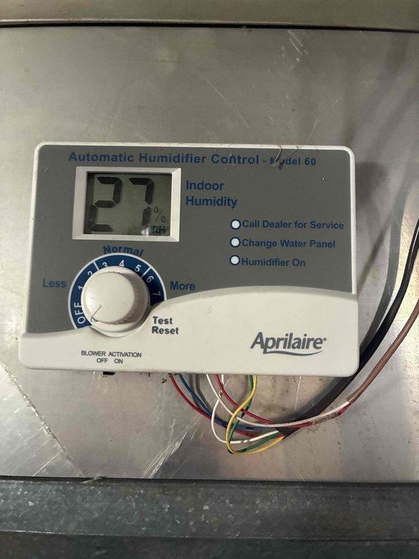 Performed inspection of Aprilaire humidifier system and found indoor relative humidity at 27%. Examined air filter assembly and humidifier control panel (Model 60) for proper function. No service indicator lights were active during assessment.
