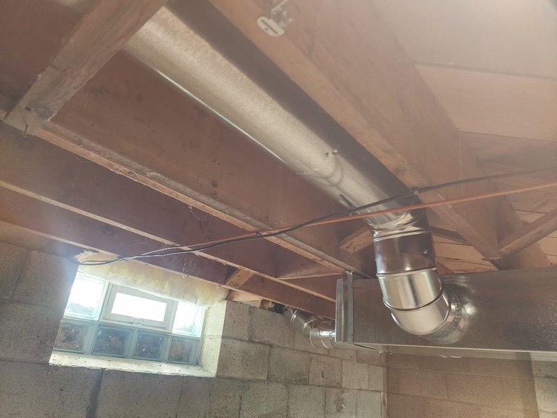 Installed and secured new metal HVAC ductwork in unfinished basement, including proper installation of a 90-degree elbow joint. All connections were sealed with metal tape to ensure system integrity and efficiency.