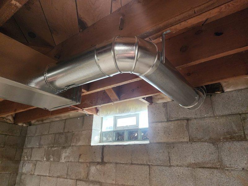 Installed and secured new metal HVAC ductwork in unfinished basement, including proper installation of a 90-degree elbow joint. All connections were sealed with metal tape to ensure system integrity and efficiency.