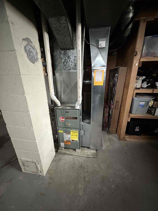 Completed installation of a new Rheem furnace unit in basement mechanical room, properly connecting to existing ductwork system and verifying electrical connections at the main panel. The new unit replaced aging equipment and was installed according to manufacturer specifications with all required safety labels in place.