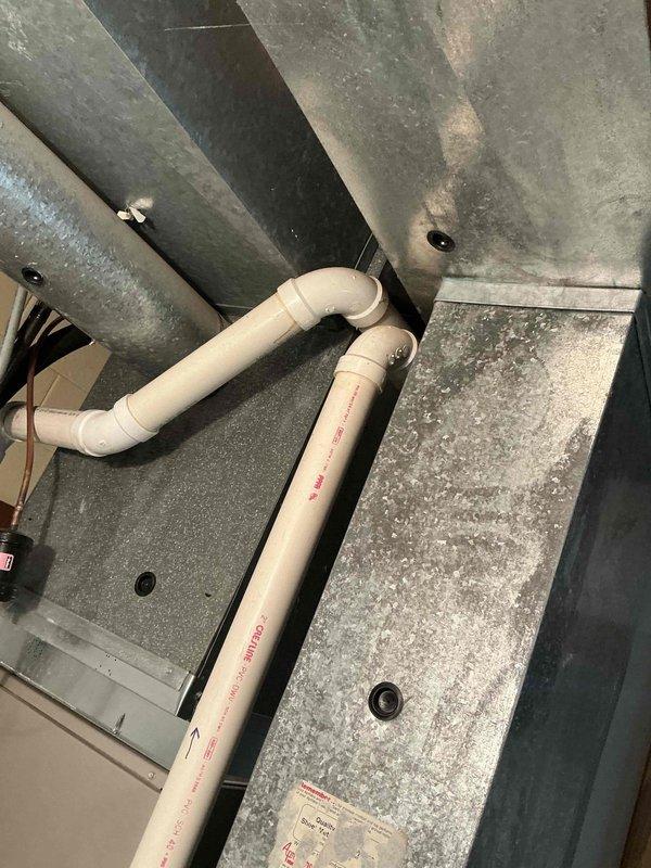Conducted comprehensive evaluation of existing HVAC system, including inspection of interior air handler with connected PVC condensate drainage pipes and exterior condensing unit. Provided detailed replacement estimate for aging system showing signs of normal wear, including new unit installation on existing concrete pad with proper electrical disconnect and refrigerant line connections.