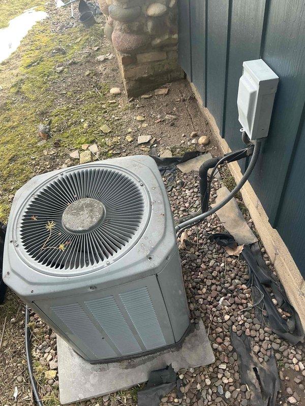 Conducted comprehensive evaluation of existing HVAC system, including inspection of interior air handler with connected PVC condensate drainage pipes and exterior condensing unit. Provided detailed replacement estimate for aging system showing signs of normal wear, including new unit installation on existing concrete pad with proper electrical disconnect and refrigerant line connections.