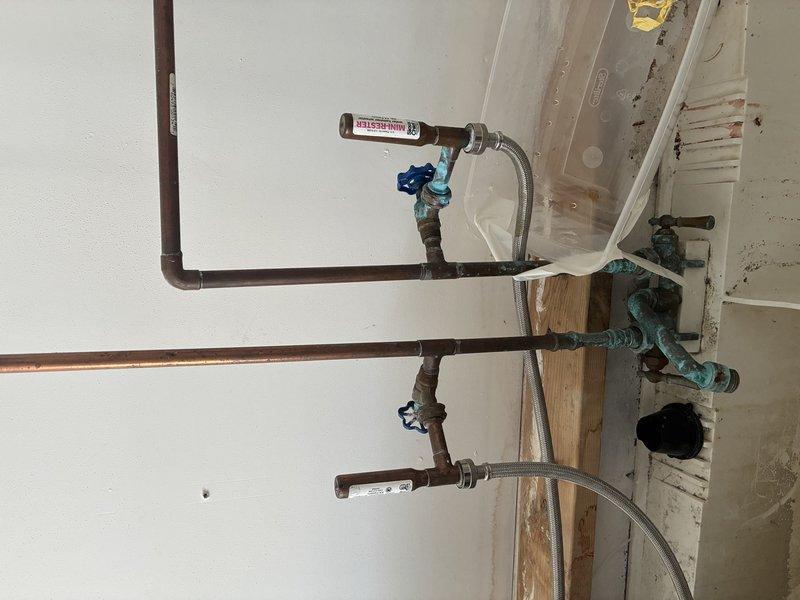 Installed new copper water supply lines with shut-off valves in renovation area. Used flexible stainless steel connectors to prepare for fixture installation. All connections secured and tested for proper function.