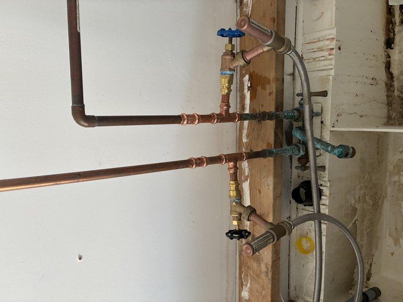 Installed new copper water supply lines with shut-off valves in renovation area. Used flexible stainless steel connectors to prepare for fixture installation. All connections secured and tested for proper function.