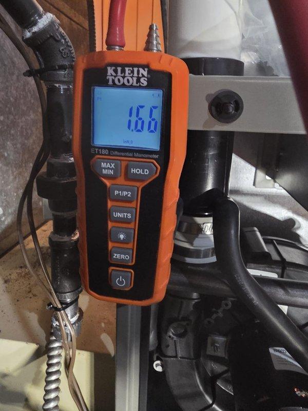 Successfully installed new furnace with proper pressure testing completed. Conducted differential pressure measurements using Klein Tools ET180 manometer, confirming readings of 16.6 InH₂O and 14.4 InH₂O, which fall within manufacturer specifications. System is now operational with all connections properly sealed and tested.
