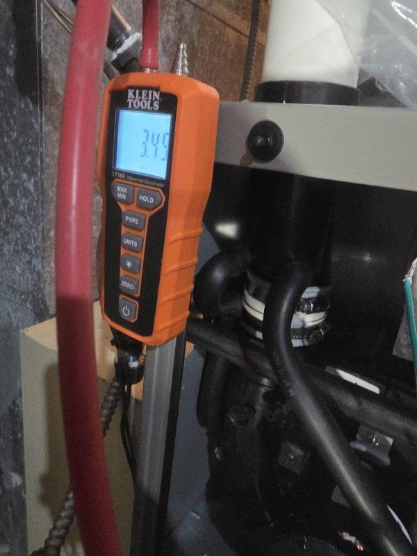 Successfully installed new furnace with proper pressure testing completed. Conducted differential pressure measurements using Klein Tools ET180 manometer, confirming readings of 16.6 InH₂O and 14.4 InH₂O, which fall within manufacturer specifications. System is now operational with all connections properly sealed and tested.