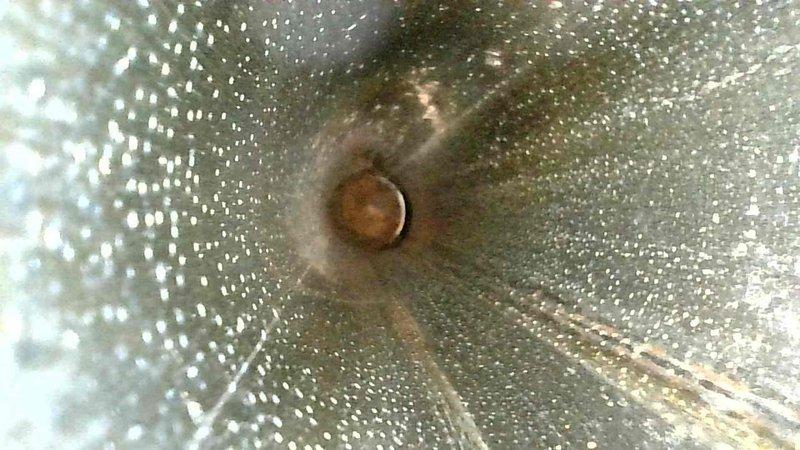 Performed comprehensive inspection of ductwork system, identifying significant dust accumulation and early-stage corrosion at connection points. Interior examination revealed perforated sections with visible rust formation and debris buildup that could potentially restrict airflow and reduce system efficiency.