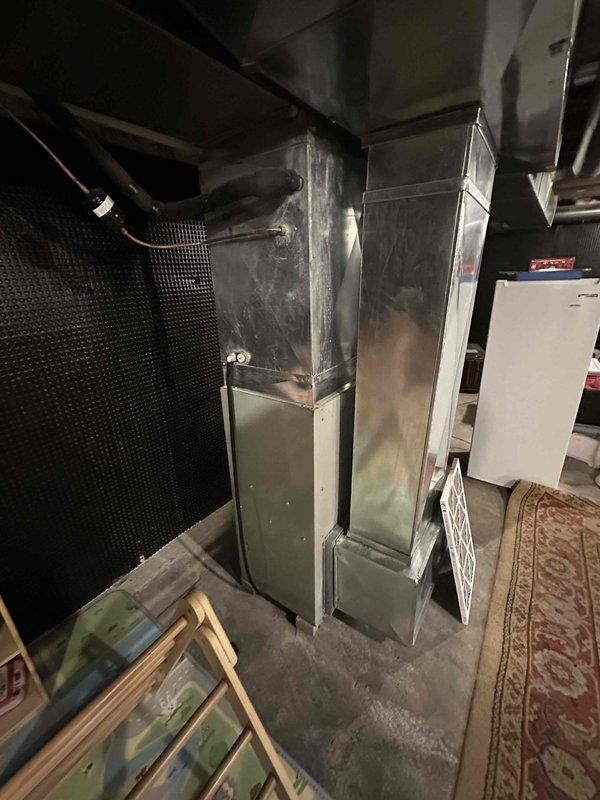 Conducted a comprehensive evaluation of existing HVAC system including furnace unit and associated ductwork in basement utility area. Documented current installation conditions showing galvanized sheet metal ductwork configuration, PVC venting, and connection points. Prepared replacement estimate for complete system upgrade based on observed equipment age and installation parameters.