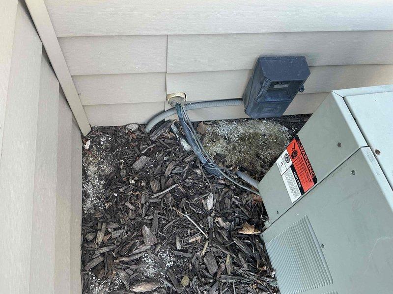 # HVAC Estimate - Replacement Summary

Conducted comprehensive site evaluation for complete HVAC system replacement at residential property. Assessment included exterior condenser unit location with existing electrical service and interior mechanical room containing aged copper piping infrastructure, water heater connections, and ductwork distribution system requiring modernization to accommodate new high-efficiency heating and cooling equipment.

## Detailed Job Description

Performed thorough on-site evaluation for complete HVAC system replacement project. Exterior assessment documented existing condenser pad location adjacent to building foundation with established electrical service infrastructure, including weathered disconnect box and metering equipment mounted on exterior wall. Evaluated ground conditions and mulch bed area for potential equipment placement and clearance requirements per manufacturer specifications.

Interior mechanical room inspection revealed extensive copper 