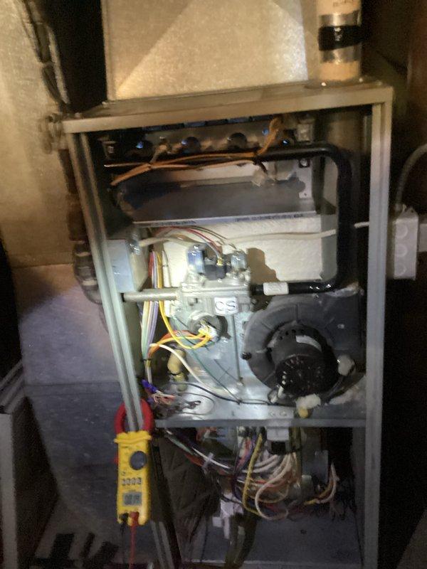 # HVAC Service Report - No Heat Call

## Summary
Responded to no heat call on 10+ year old residential furnace system. Performed diagnostic testing and inspection of internal components, identifying issues with aged pressure switch tubing and electrical connections requiring attention.

## Work Performed

Upon arrival, conducted systematic diagnostic evaluation of furnace unit experiencing no heat condition. Removed front access panel to access internal components for thorough inspection and testing.

Utilized digital diagnostic equipment to measure and verify system performance parameters. Conducted visual inspection of all major components including blower motor assembly, evaporator coil section, control board, and associated electrical connections.

Identified deteriorated pressure switch tubing showing signs of age-related discoloration and potential integrity issues. This yellowish-beige rubber tubing exhibited hardening and brittleness common in units of this age, which can cause