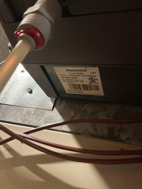 # HVAC Service Report - Furnace Maintenance

Performed comprehensive inspection and maintenance service on residential forced-air heating system located in basement mechanical room. System consists of central air handler unit with integrated ductwork distribution system and Honeywell HE225A flow-through humidifier mounted on supply plenum.

Conducted thorough visual inspection of air handler cabinet, noting accumulated dust and debris on exterior surfaces and surrounding ductwork components. Inspected all accessible ductwork connections including horizontal supply trunk lines and flexible duct transitions for proper sealing and structural integrity. Verified secure mounting of all equipment and absence of excessive vibration points.

Examined whole-home humidification system including Honeywell HE225A unit mounted to supply duct. Inspected copper water supply line with shutoff valve for proper connection and absence of leaks. Verified humidistat wiring connections and control circuit f