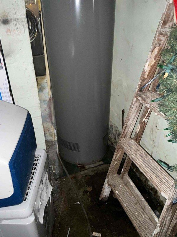 # HVAC Estimate - Replacement Summary

Conducted comprehensive assessment of existing HVAC system and water heater in basement utility room for replacement estimate. Evaluated current gray cylindrical water heater unit with copper piping connections, noting moisture staining on concrete floor and signs of age. Inspected existing air handler unit with metal ductwork and black flexible ducting, along with reflective insulated ductwork running along ceiling joists. Documented equipment specifications, spatial constraints, existing infrastructure connections, and utility room configuration to provide accurate replacement recommendations for both water heating and HVAC systems.