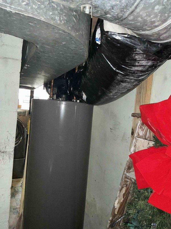 # HVAC Estimate - Replacement Summary

Conducted comprehensive assessment of existing HVAC system and water heater in basement utility room for replacement estimate. Evaluated current gray cylindrical water heater unit with copper piping connections, noting moisture staining on concrete floor and signs of age. Inspected existing air handler unit with metal ductwork and black flexible ducting, along with reflective insulated ductwork running along ceiling joists. Documented equipment specifications, spatial constraints, existing infrastructure connections, and utility room configuration to provide accurate replacement recommendations for both water heating and HVAC systems.