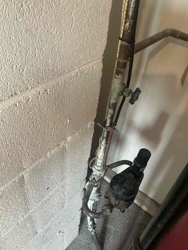# HVAC Estimate - Replacement Summary

Conducted comprehensive assessment of existing hydronic heating system showing significant deterioration and corrosion throughout circulation pump assembly and associated piping infrastructure. Documentation revealed extensive mineral deposits, oxidation on copper and metal piping connections, and aging pump unit with compromised fittings requiring complete system replacement to ensure reliable heating operation and prevent potential failure.

# Detailed Assessment

The inspection identified a ceiling-mounted circulation pump assembly with multiple copper and metal pipe connections exhibiting advanced corrosion and mineral buildup. The pump unit displayed considerable weathering with darkened housing and deteriorated surface finish. Critical observations included white crusty deposits indicating long-term water seepage or condensation issues, oxidation on pipe joints and fittings, and visible wear on metal surfaces throughout the assembly.

The pi