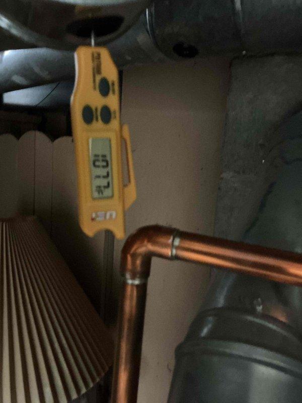 # HVAC Service - Furnace Job Description

Performed diagnostic service on residential furnace system. Upon arrival, conducted temperature measurements along copper refrigerant lines using calibrated digital thermometer to assess system performance and verify proper heat transfer. Reading of 31.3°F was recorded at copper pipe elbow joint near heat exchanger assembly.

Inspected heat exchanger fins and copper piping connections for proper installation, leaks, and overall system integrity. All solder joints on copper lines were verified to be secure with no visible signs of deterioration or refrigerant leakage. Heat exchanger surfaces showed normal operating condition with clean, unobstructed fins allowing for adequate airflow.

System diagnostics completed successfully with all measurements within acceptable operating parameters. No repairs required at this time. Furnace system operational and functioning as designed.