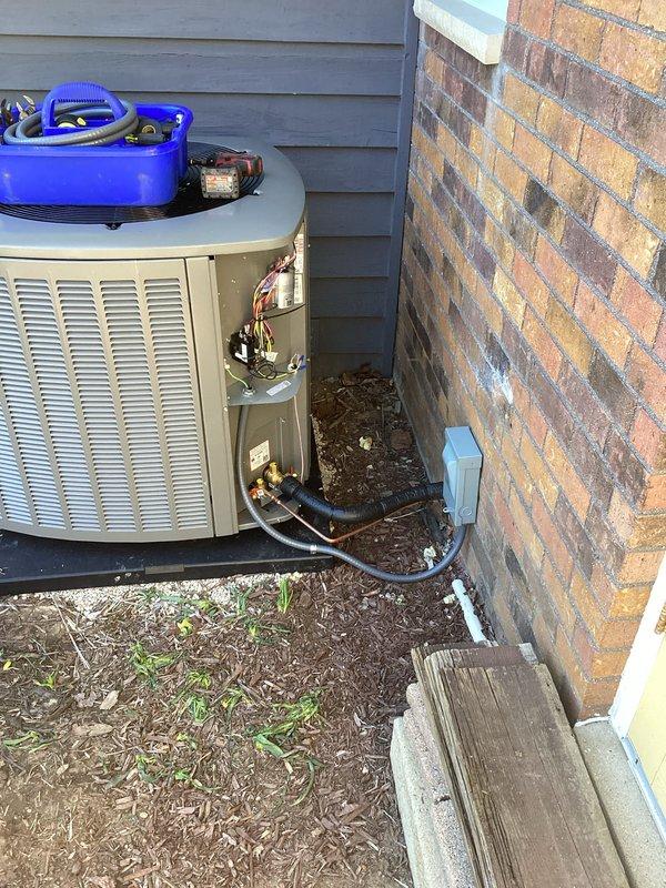 # HVAC Install - Complete System

## Job Description

Completed full HVAC system installation including outdoor condensing unit and indoor furnace. Installed Lennox furnace in basement mechanical room with proper clearances and code-compliant positioning on concrete slab. Routed refrigerant lines through exterior wall penetration, connecting outdoor unit to indoor air handler with appropriate insulation on suction line. Installed condensing unit on level pad between building structures with adequate service clearance. 

Configured PVC condensate drain and intake/exhaust venting from furnace through basement ceiling joists with proper pitch and support. Ran electrical disconnects and control wiring between indoor and outdoor components. Pressure tested refrigerant lines for leaks, evacuated system to proper vacuum levels, and charged unit to manufacturer specifications using calibrated gauges. Verified proper airflow, temperature split, and superheat/subcooling readings. 

System tested
