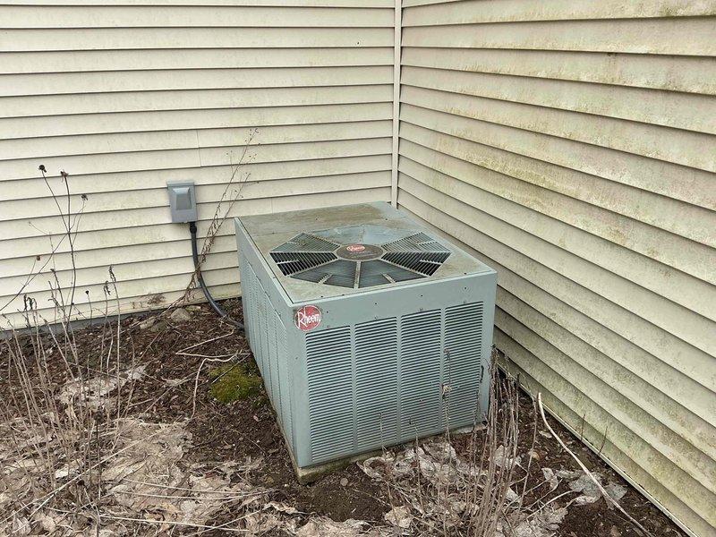 Completed comprehensive HVAC system evaluation for equipment replacement estimate at residential property. Assessment included existing Rheem furnace installation in basement utility area with connected air handler and filter housing, plus exterior air conditioning unit positioned in side yard corner showing signs of weathering and requiring attention to surrounding clearance area. Documented current system configuration, equipment specifications, and installation conditions to provide accurate replacement recommendations for complete heating and cooling system upgrade.