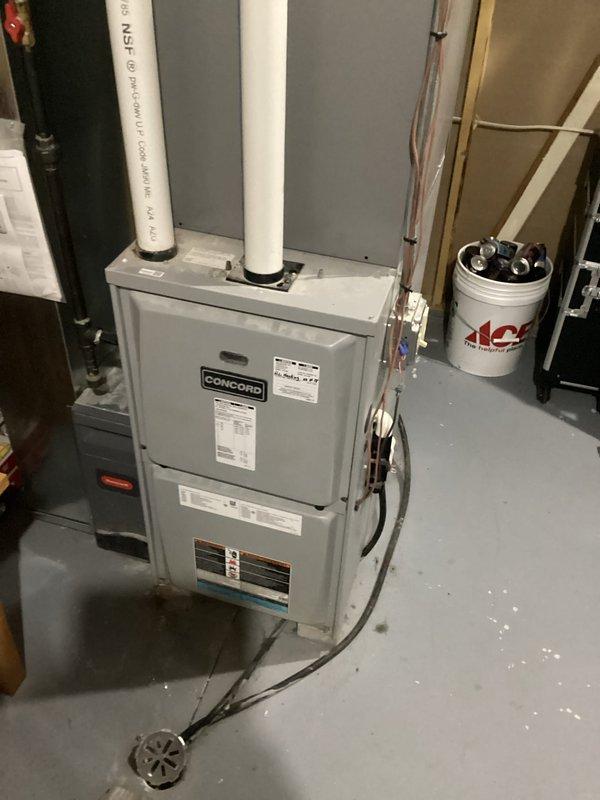 Performed routine maintenance inspection on Concord brand residential furnace system. Accessed and examined blower motor assembly, verified proper operation of all mechanical components, and inspected electrical connections throughout the unit. Confirmed integrity of PVC venting system, drainage connections, and associated plumbing lines, with all equipment operating within normal parameters at time of service.