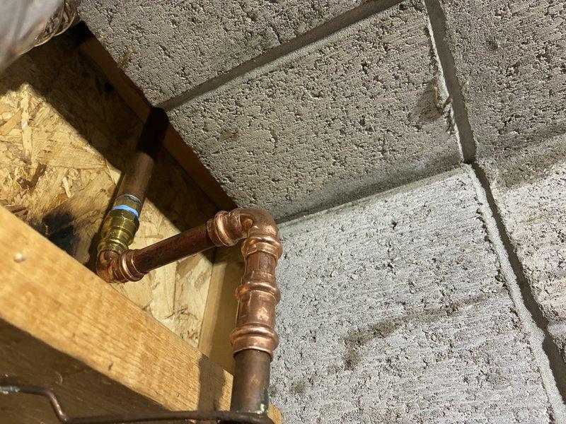 # Plumbing Service - Broken/Burst Pipe

Responded to emergency call for burst pipe repair in residential property. Upon arrival, assessed water damage and located compromised copper supply line behind bathroom wall. Shut off main water supply to prevent further flooding and property damage.

Removed section of damaged drywall to access plumbing system. Found corroded copper pipe with pinhole leak that had expanded due to water pressure, causing significant water discharge into wall cavity and bathroom area. Extracted affected pipe section and inspected surrounding plumbing infrastructure for additional compromise.

Installed new copper pipe segment using compression fittings and proper soldering techniques to ensure watertight seal. Verified all connections met code requirements and tested system integrity under full water pressure. Confirmed no additional leaks present at joints or surrounding plumbing fixtures including tub spout and shower assembly.

Restored water supply and conduc