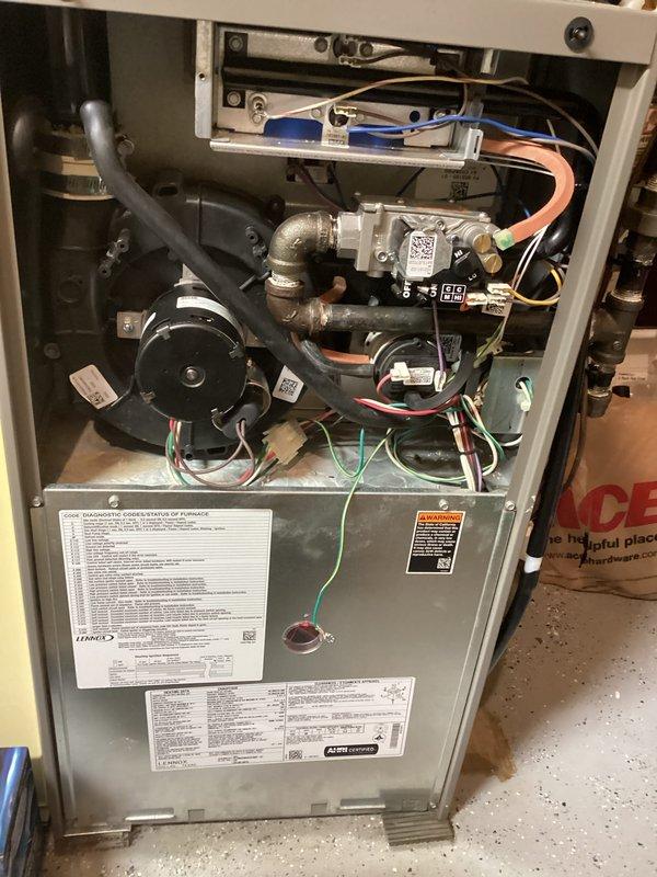 Completed furnace repair involving inspection and servicing of internal heating system components. Accessed furnace cabinet to examine electrical connections, pressure switches, gas valve assembly, and condensate drainage system. Verified proper operation of safety controls and tested all electrical connections throughout the unit. Inspected and serviced PVC condensate drain lines and mounting hardware to ensure proper drainage function. All components tested and confirmed operational upon completion of service work.