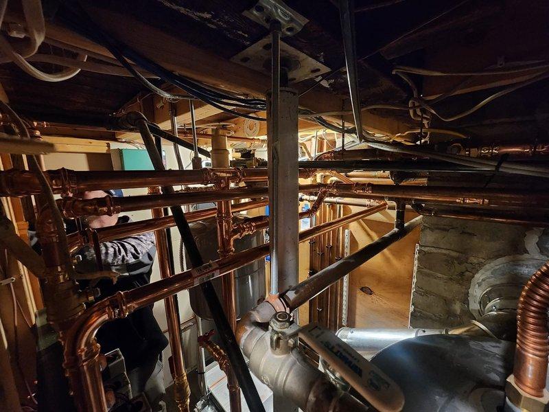 # HVAC Install - Boiler

Completed comprehensive boiler installation in mechanical room including full integration with existing plumbing infrastructure. Installed new boiler system with extensive copper piping network featuring multiple diameter runs for supply and return lines, ensuring proper water circulation throughout the heating system. Configured all necessary connections to water heater, expansion tank, and distribution manifolds with professional soldered joints and appropriate isolation valves for future serviceability.