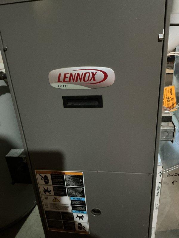 # HVAC Service Report - No Heat Call

Responded to no heat call on Lennox Elite furnace system. Upon arrival, conducted visual inspection of unit and opened access panel to examine internal components. Found unit in non-operational state with no active heating cycle.

Performed thorough diagnostic inspection of electrical and mechanical systems within furnace compartment. Examined control board, wiring connections, capacitors, and associated components for signs of failure or malfunction. Noted significant discoloration and residue accumulation on lower metal shelf inside unit, indicating possible previous moisture intrusion or operational issues.

Inspected all wire bundles and electrical connections throughout the system, including multi-colored wiring harnesses secured with zip ties. Verified integrity of connections between control systems and operational components. Checked capacitors, motor assemblies, and related electrical devices for proper function and secure mounting.

Asses