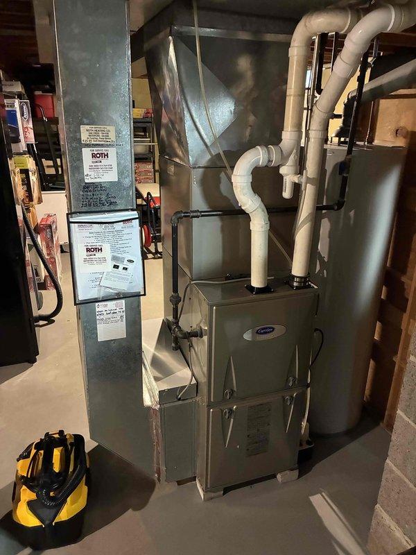 Completed prepaid HVAC maintenance visit on residential Carrier furnace system located in basement mechanical room. Performed comprehensive system inspection including verification of thermostat operation and programming settings, confirmed unit was maintaining proper setpoint of 73°F in heating mode with hold schedule active. Conducted visual inspection of furnace cabinet, ductwork transitions, PVC venting system, and associated mechanical components to ensure proper operation and identify any potential service needs.