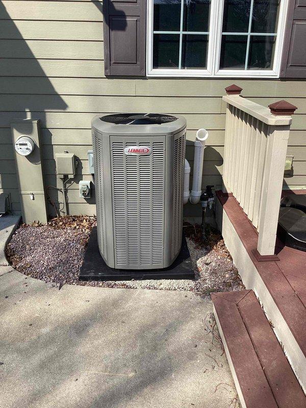 Completed installation of Lennox EL18KCV-048-230B04 outdoor condensing unit with matching evaporator coil system. Unit was positioned on gravel pad against exterior wall with proper clearances maintained, electrical connections completed per manufacturer specifications at 208/230V single-phase service, refrigerant lines installed and system charged with 10 lbs 1 oz of R-454B refrigerant per factory specifications. Condensate drain line installed with PVC piping, all electrical requirements met including 50-amp maximum overcurrent protection and minimum circuit ampacity of 28.7 amps. System startup performed, operational parameters verified, and unit tested for proper cooling operation.