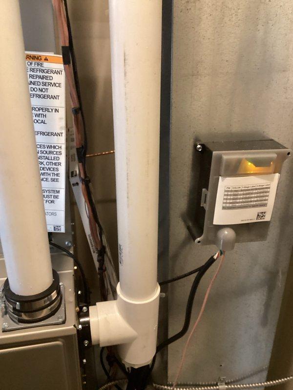 Completed full HVAC system installation in residential mechanical space, including new air handler unit with condensate drain pan, PVC drain lines, refrigerant line sets with insulation, and electrical connections. Installed safety controls including float switch assembly and mounted electrical disconnect box with proper labeling per code requirements. All components tested and verified operational upon completion.