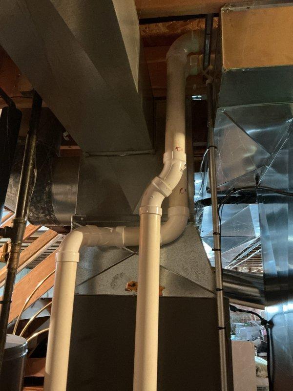 Completed comprehensive HVAC system tune-up in attic mechanical space, inspecting all ductwork connections, PVC condensate drain lines, and copper refrigerant lines for proper operation. Verified all sheet metal plenums, flexible ductwork, and pipe joints showed no signs of leakage or deterioration, with all components functioning within normal parameters.