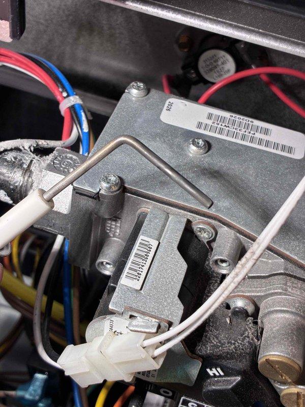 Performed comprehensive HVAC tune-up and system diagnostics on heating equipment. Conducted electrical testing using digital multimeter, recording voltage readings of 52.47V to verify proper power supply and system operation. Inspected gas valve assembly, control wiring, and electrical connections for proper operation and safety compliance. All components including capacitor, control board wiring, and gas valve assembly found to be functioning within manufacturer specifications with normal wear patterns for equipment age.