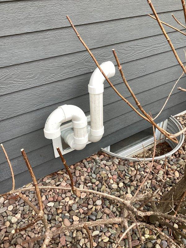 Installed new PVC condensate drain line assembly on building exterior, routing drainage away from foundation with properly configured elbows and fittings. Secured drain termination points through wall-mounted junction plate and verified proper pitch for gravity drainage. System tested and operational with no leaks detected.