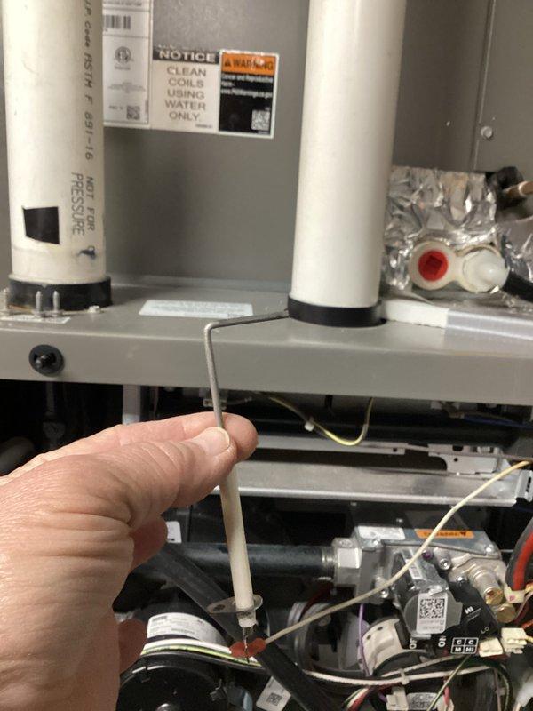 Completed prepaid HVAC maintenance visit on residential water heater unit. Performed standard system inspection using diagnostic probe to test internal components and verify proper operation of gas valve assembly, electrical connections, and safety controls. Confirmed compliance with manufacturer specifications including coil cleaning requirements as indicated on unit labeling. All components found operating within normal parameters, with white PVC vent piping and gas supply connections properly secured and functioning correctly.