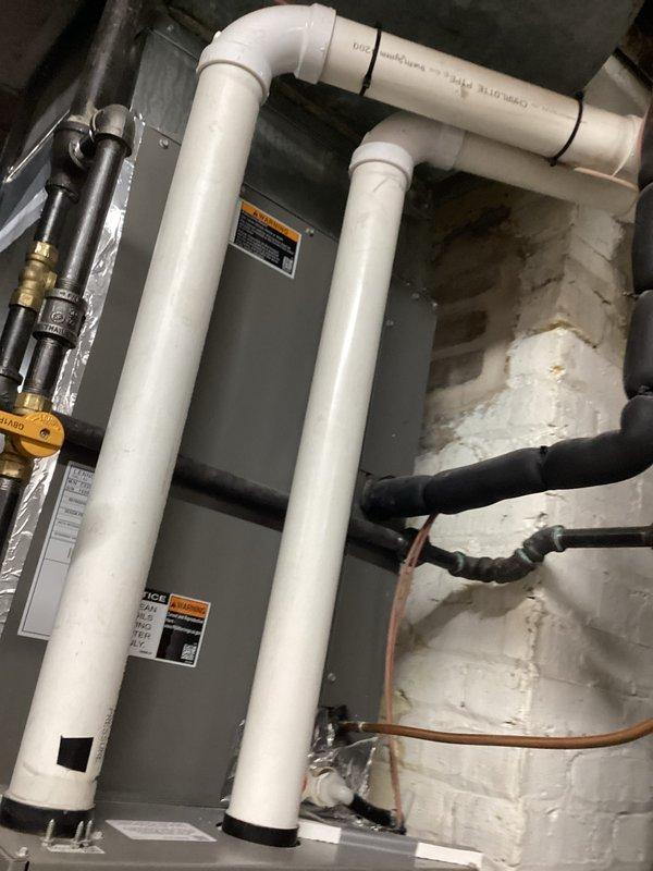 Completed prepaid HVAC maintenance visit on residential water heater unit. Performed standard system inspection using diagnostic probe to test internal components and verify proper operation of gas valve assembly, electrical connections, and safety controls. Confirmed compliance with manufacturer specifications including coil cleaning requirements as indicated on unit labeling. All components found operating within normal parameters, with white PVC vent piping and gas supply connections properly secured and functioning correctly.