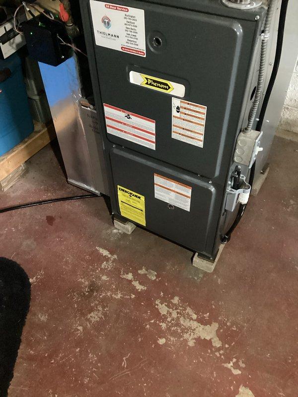 Completed installation of new air conditioning system and evaporator coil in residential property. The new HVAC equipment was installed in the basement utility area, with proper integration to existing ductwork and drainage systems, including PVC condensate lines routed through floor penetrations. All connections were secured, system was tested for proper operation, and unit is functioning within manufacturer specifications.