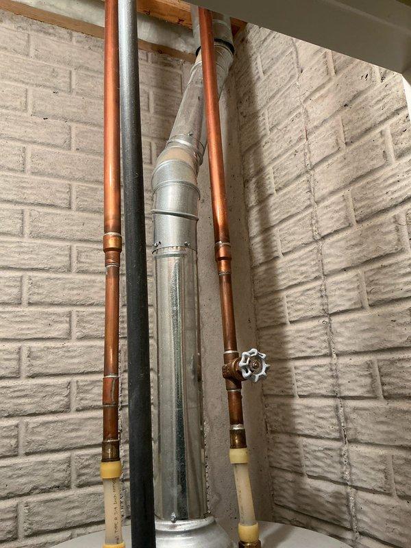 Completed comprehensive assessment of existing HVAC system and water heating equipment for replacement estimate. Documented current installation including Bradford White Defender water heater with associated copper supply lines, brass fittings, and pressure relief valve assembly. Evaluated existing ductwork configuration featuring galvanized metal supply duct, copper refrigerant lines, and PEX plumbing distribution system running through floor joists in basement utility area. Photographed all mechanical systems and provided detailed replacement recommendations to customer.