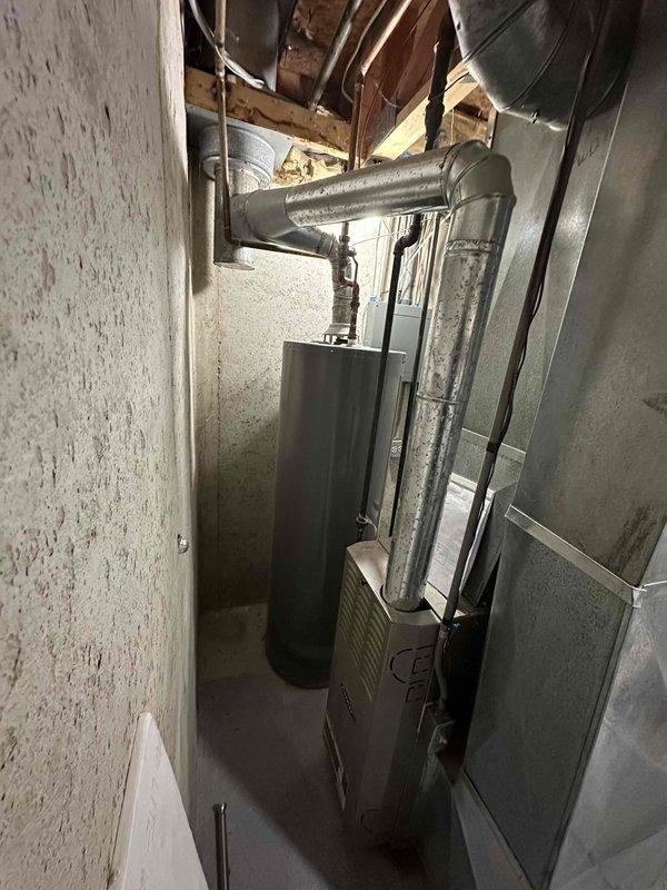 Completed comprehensive HVAC system replacement estimate for residential property. Assessed existing furnace unit located in basement mechanical room and evaluated current ductwork configuration, including main trunk lines and vertical distribution sections. Documented exterior utility connections and meter locations to determine optimal equipment placement and necessary modifications for new system installation.