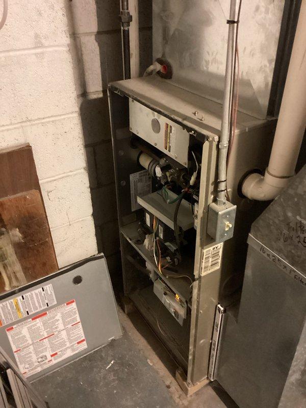 Performed routine furnace inspection and maintenance on residential gas-fired heating system. Accessed internal components through front panel to verify proper operation of blower motor assembly, heat exchanger, burners, and associated mechanical systems. All components found to be functioning within normal parameters, with unit properly vented through existing PVC piping system.
