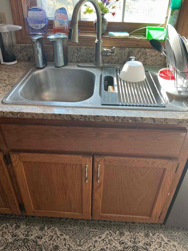 # Plumbing Estimate - Water Service

Conducted comprehensive water service assessment for residential property. Evaluated kitchen plumbing infrastructure including sink drainage system, faucet assembly, and under-counter supply lines. Inspected laundry area water connections serving washing machine, examining hot and cold water supply valves, hose connections, and drain standpipe configuration to ensure proper flow rates and identify potential leak points or code compliance issues.