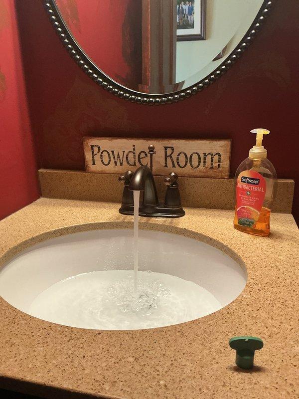 Completed plumbing estimate for powder room fixture replacement. Assessed existing undermount sink with bronze two-handle faucet and evaluated under-cabinet plumbing configuration, including PVC P-trap assembly, chrome tailpiece with mounting flange, and flexible braided water supply lines. Provided detailed estimate for potential fixture upgrades and plumbing component replacements as requested.