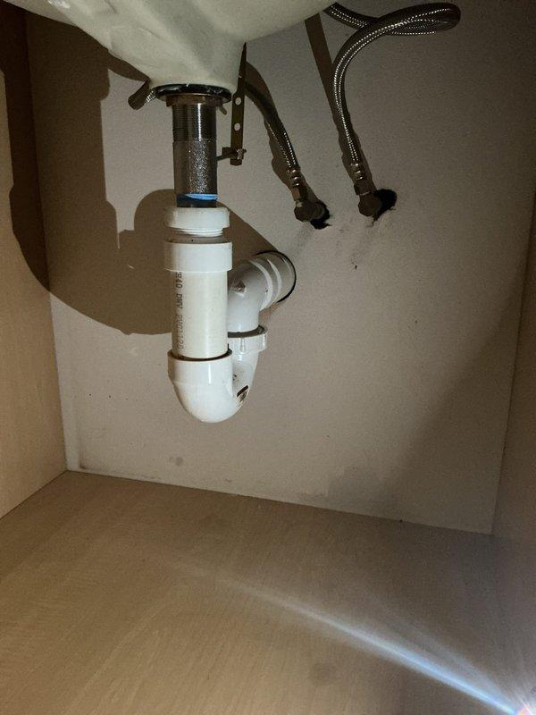 Completed plumbing estimate for powder room fixture replacement. Assessed existing undermount sink with bronze two-handle faucet and evaluated under-cabinet plumbing configuration, including PVC P-trap assembly, chrome tailpiece with mounting flange, and flexible braided water supply lines. Provided detailed estimate for potential fixture upgrades and plumbing component replacements as requested.