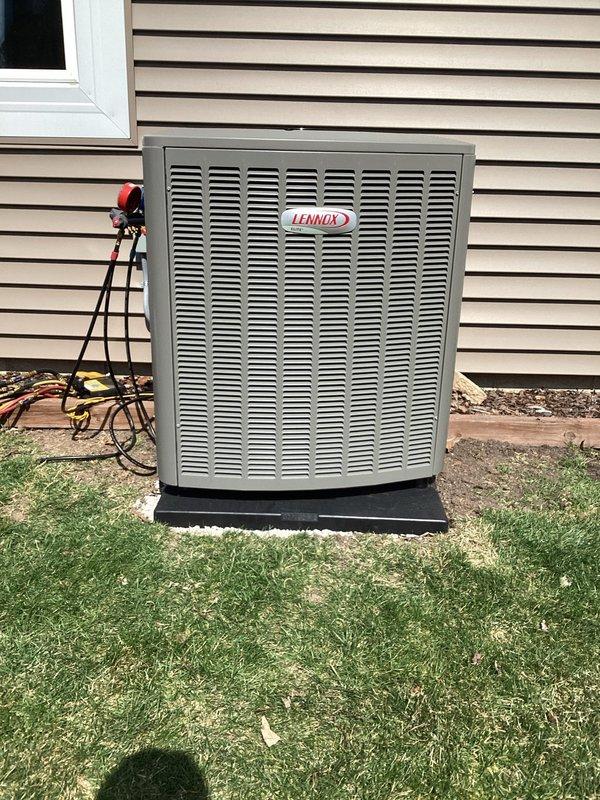 Completed installation of new Lennox air conditioning system with matching evaporator coil. Installed outdoor condensing unit on level pad against exterior wall with proper clearances, ran and insulated refrigerant line set through wall penetration, and mounted new evaporator coil above existing furnace in basement utility area. Connected electrical supply to outdoor unit, installed proper disconnect, and ran low voltage control wiring between indoor and outdoor components. Installed new PVC condensate drain line from coil with proper trap and termination. Pressure tested refrigerant lines for leaks, pulled vacuum on system to remove moisture and contaminants, and charged system to manufacturer specifications. Verified all electrical connections are secure and properly sized. Started system and confirmed proper operation of compressor, condenser fan, and indoor blower. Checked refrigerant pressures and temperatures to ensure system is operating within normal parameters. Verified adequa